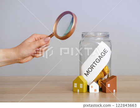 Bank of coins Mortgage. The accumulation of money to pay interest rates on mortgages. Buying a property in debt. Take credit for housing. Mortgage tax and loan concept. 122843663