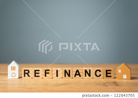 Wooden blocks with the words Refinance and miniature houses. Real estate concept. Business and finance. Mortgage, loan. Interest rates. Home lending 122843705
