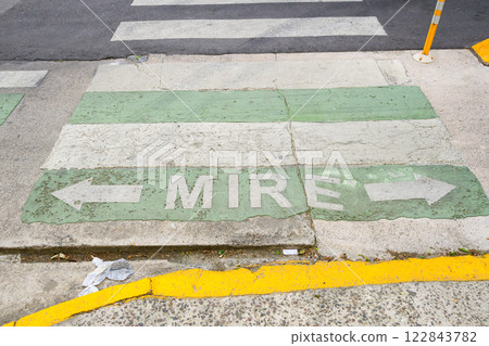 The word mire is clearly painted on the sidewalk by a crosswalk The word mire is clearly painted on the sidewalk by a crosswalk 122843782