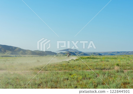 hang glider takeoff in the Kazakh steppe. light aircraft with a pilot and passenger hang glider takeoff in the Kazakh steppe. light aircraft with a pilot and passenger 122844501