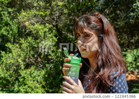 portrait of a woman drinking water portrait of a woman drinking water 122845366