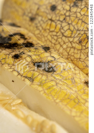 spoiled melon with black spots from mold and mildew 122845448