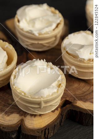 waffle cups with buttercream during dessert cooking 122845524
