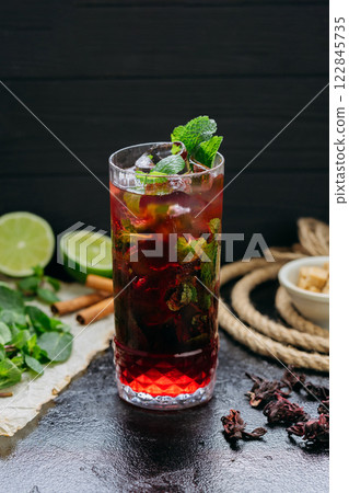 Refreshing hibiscus cocktail with lime, mint, and ice in a tall glass, summer and tropical vibes Refreshing hibiscus cocktail with lime, mint, and ice in a tall glass, summer and tropical vibes 122845735
