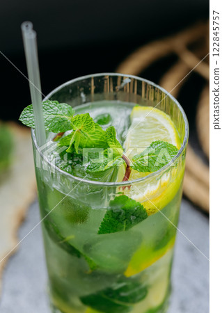 Refreshing mojito cocktail with lime, mint, and ice, served in a tall glass for summer drink 122845757