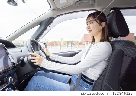 Young woman driving car navigation 122846122