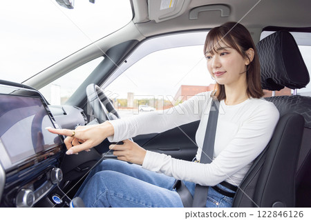 Young woman driving car navigation 122846126