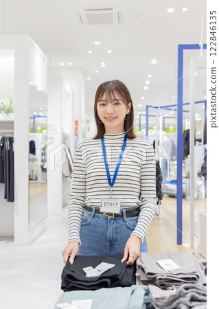 Woman working at an apparel store 122846135