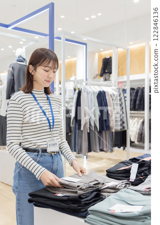 Woman working at an apparel store 122846136