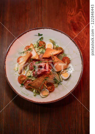 Caesar salad with bacon is mouthwatering and Caesar salad with bacon is mouthwatering and 122846443