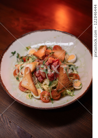 Caesar salad with bacon is mouthwatering and Caesar salad with bacon is mouthwatering and 122846444