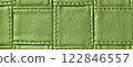Texture green leather background with square pattern and stitch, macro. Abstract olive backdrop from textile 122846557
