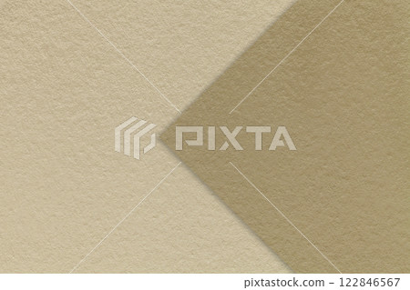 Texture beige paper background, half two colors with brown arrow, macro. Structure dense craft sand cardboard. 122846567