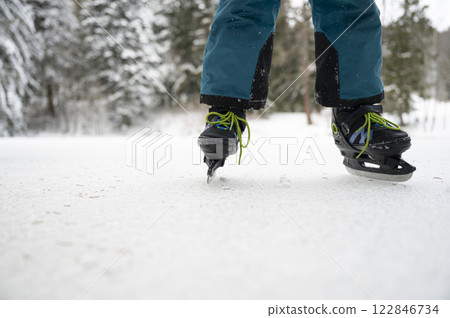 Low angle closeuo view of a childs legs ice skating on a natural ice Low angle closeuo view of a childs legs ice skating on a natural ice 122846734