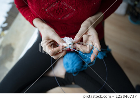 Woman knitting in cosy setting Woman knitting in cosy setting 122846737