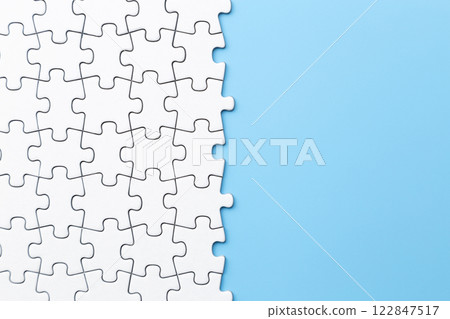 Plain jigsaw puzzle on a blue background 122847517