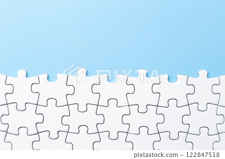 Plain jigsaw puzzle on a blue background 122847518
