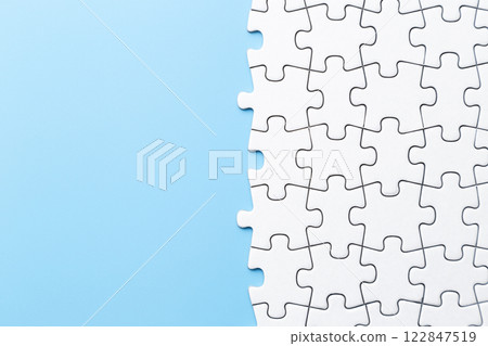 Plain jigsaw puzzle on a blue background 122847519