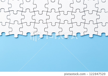 Plain jigsaw puzzle on a blue background 122847520