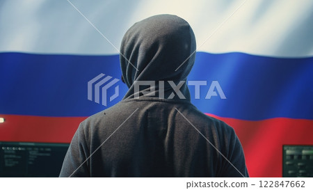 Expert in governmental hacking room with a Russian flag on big screen, individual in cyberwarfare and propaganda. Russian federation hacker works on sabotage and political manipulation. Camera B. Expert in governmental hacking room with a Russian flag on big screen, individual in cyberwarfare and propaganda. Russian federation hacker works on sabotage and political manipulation. Camera B. 122847662