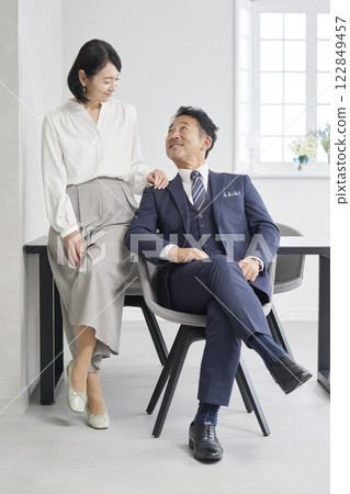 Businesswoman and businessman having a conversation in the office, full body Businesswoman and businessman having a conversation in the office, full body 122849457