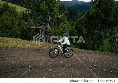 Riding mountain bike on forest mountain trail 122849694