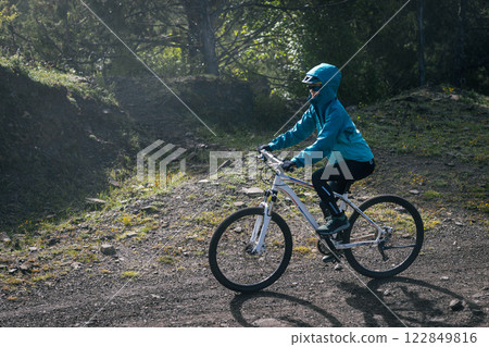 Woman riding mountain bike in forest mountain 122849816