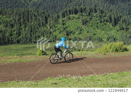 Woman riding mountain bike in forest mountain 122849817