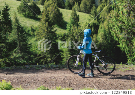 Woman riding mountain bike in forest mountain Woman riding mountain bike in forest mountain 122849818