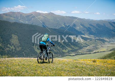 Woman riding mountain bike in forest mountain top 122849819