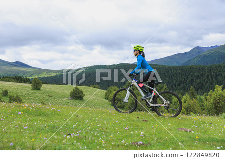 Riding mountain bike on beautiful forest mountain top Riding mountain bike on beautiful forest mountain top 122849820