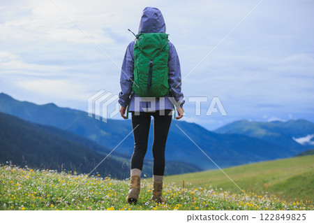 Woman hiker on beautiful flowering grassland mountain top 122849825