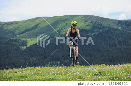Riding mountain bike on beautiful mountain top 122849831