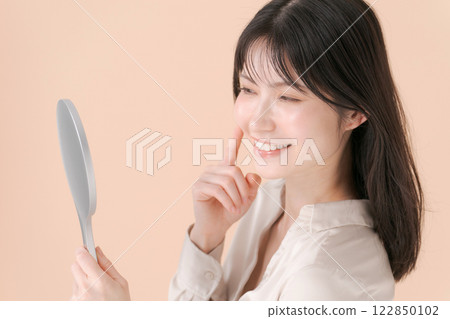 A profile of a woman looking at a mirror A profile of a woman looking at a mirror 122850102