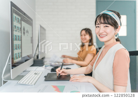 A woman who works as a photo editor, image editor, photo processor, retoucher, and graphic designer A woman who works as a photo editor, image editor, photo processor, retoucher, and graphic designer 122850128