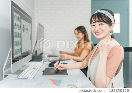 A woman who works as a photo editor, image editor, photo processor, retoucher, and graphic designer A woman who works as a photo editor, image editor, photo processor, retoucher, and graphic designer 122850129