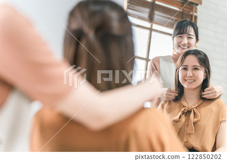 美髮師/造型師為在美容院/美髮沙龍諮詢髮型的亞洲女性顧客提供諮詢服務 122850202