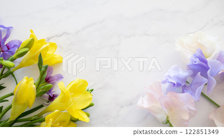 Vivid freesia and sweet pea - a bouquet background heralding the arrival of spring 122851349