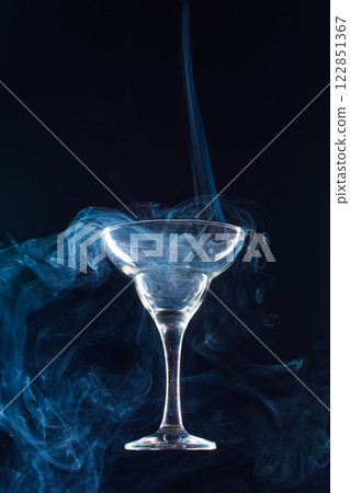 levitating glass full of smoke on a black background 122851367