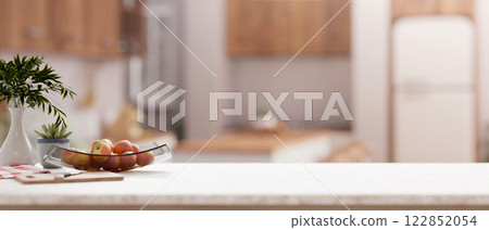 A close-up of a kitchen countertop with a blurred background of a contemporary Scandinavian kitchen. 122852054