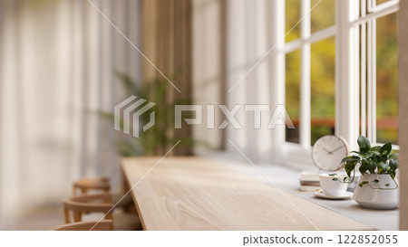 A close-up of a copy space on a wooden desk against a window in a cozy Scandinavian coffee shop. 122852055