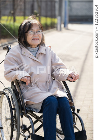 Smiling elderly person in a wheelchair Smiling elderly person in a wheelchair 122852914
