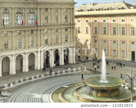 Piazza Ferrari with fountain in Genoa. Buildings and architecture of old town. View from above on sunny winter day in 2025. 122853833
