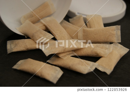 Packaging and nicotine pads on a dark background.  122853926