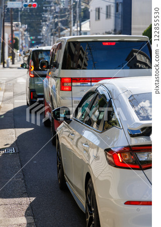 Cars stopping at a red light at an intersection 122855530