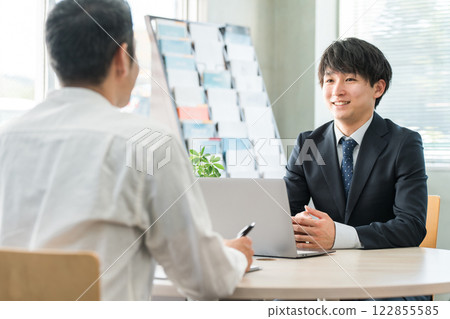 A young Asian businessman negotiating, serving and meeting with a male customer (car/insurance) A young Asian businessman negotiating, serving and meeting with a male customer (car/insurance) 122855585