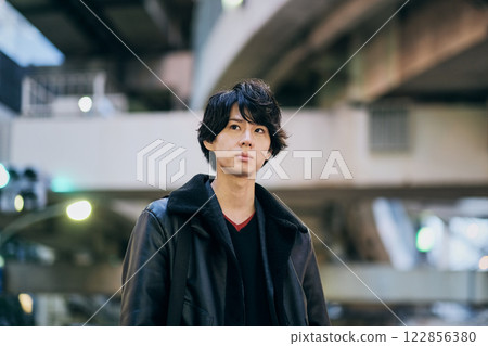 Portrait of a young man against the backdrop of a night city 122856380