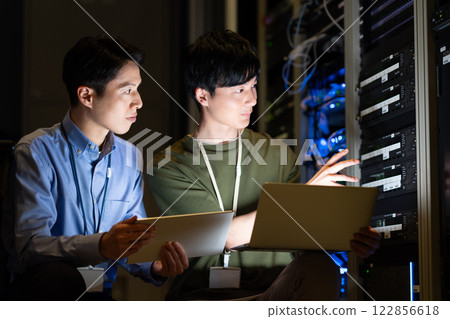 Engineers performing maintenance in the server room. Photo courtesy of Sky Perfect TV Tokyo Media Center. Engineers performing maintenance in the server room. Photo courtesy of Sky Perfect TV Tokyo Media Center. 122856618