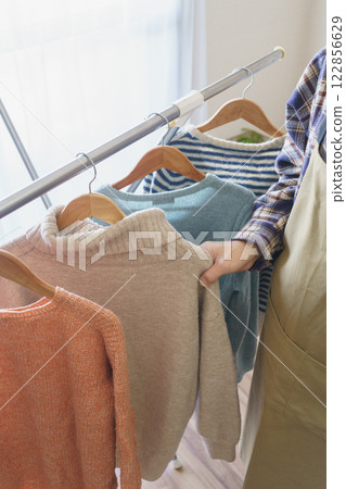 Hang the sweater on a hanger 122856629