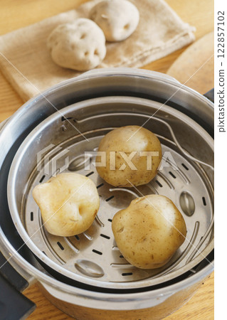 Image of steaming potatoes in a pressure cooker Image of steaming potatoes in a pressure cooker 122857102